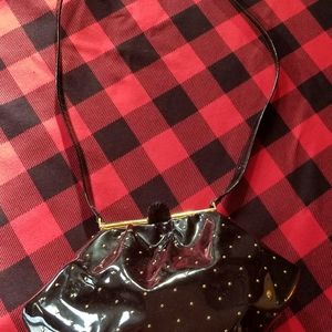 Stuart Weitzman patent leather crossbody with gold